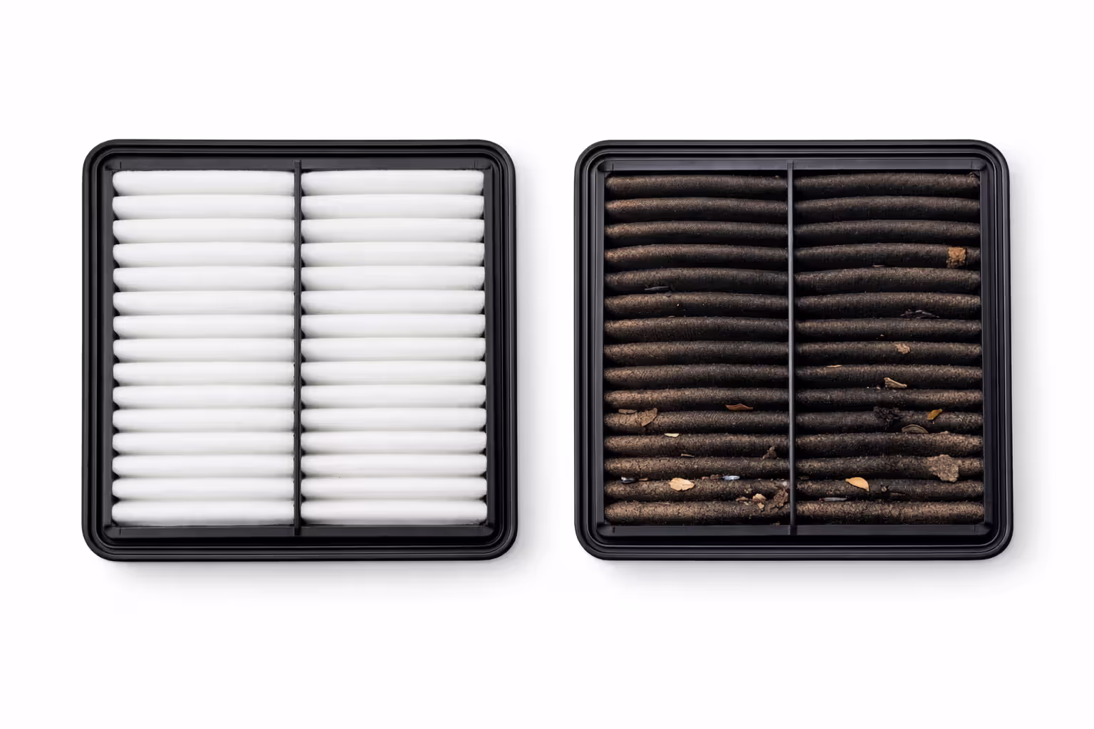 New clean white engine air filter next to a heavily clogged dark brown dirty air filter side by side on a white surface